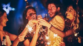 Group of friends having fun and holding sparklers at New Year's party