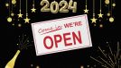 a restaurant 'open' sign on a festive new year's themed background with gold stars and fireworks